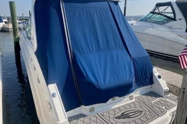 Slide: The Image of 2010 Chaparral Signature 310 boat with blue cover docked at marina. - 1