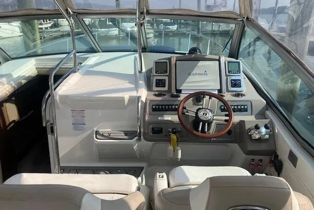 Slide: The Image of 2010 Chaparral Signature 310 boat cockpit with Garmin navigation system and leather steering wheel. - 2