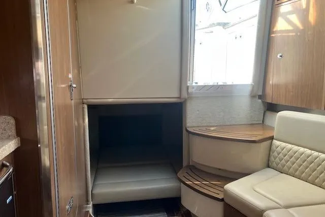 Slide: The Image of 2010 Chaparral Signature 310 cabin interior with seating and storage. - 4