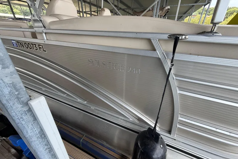 Slide: The Image of 2018 Harris FloteBote Solstice 240 pontoon boat docked, side view with registration number visible. - 10