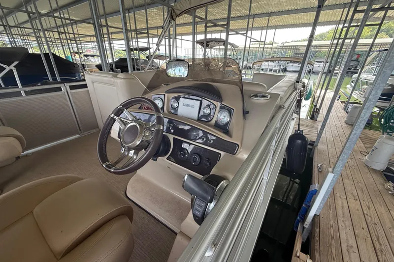 Slide: The Image of 2018 Harris FloteBote Solstice 240 pontoon boat interior with steering wheel and dashboard. - 3