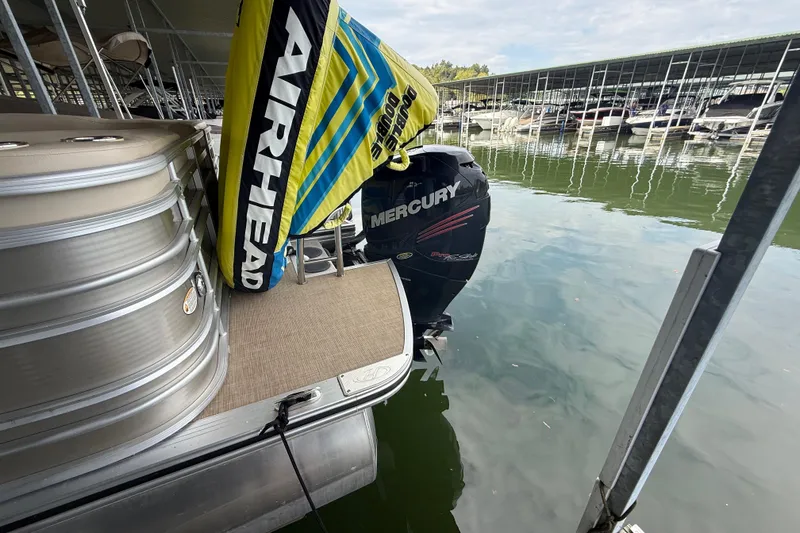 Slide: The Image of 2018 Harris FloteBote Solstice 240 pontoon with Mercury outboard motor at marina dock. - 8