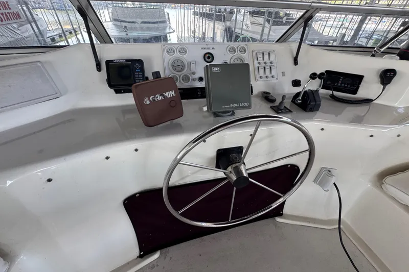 Slide: The Image of 2002 Sumerset houseboat on a lake, surrounded by lush green trees and clear blue sky. - 10