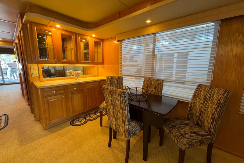 Slide: The Image of 2002 Sumerset houseboat helm with scenic lake view and lush green shoreline. - 17