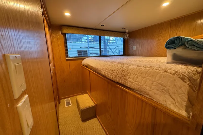 Slide: The Image of 2002 Sumerset Houseboat with outdoor kitchen, featuring a mini fridge and storage cabinets. - 21