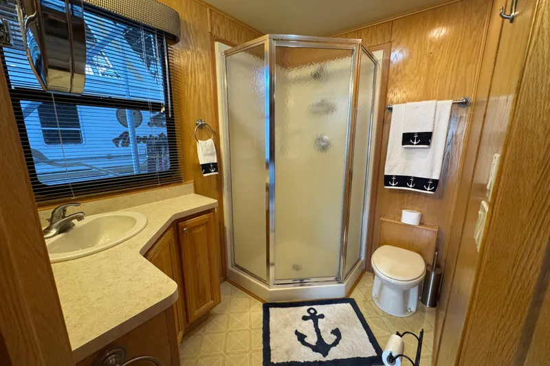 Slide: The Image of 2002 Sumerset houseboat deck with table, chairs, and scenic lake view. - 24