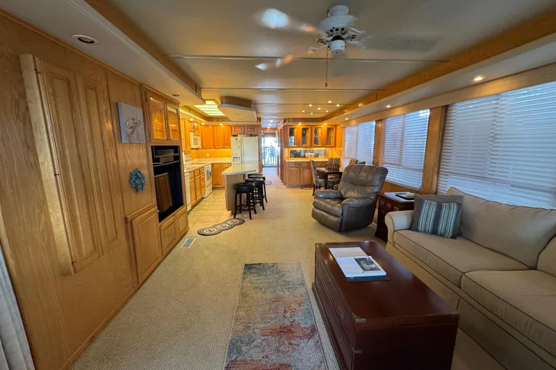 Slide: The Image of 2002 Sumerset houseboat deck with fishing rods, ceiling fan, and scenic lake view. - 26