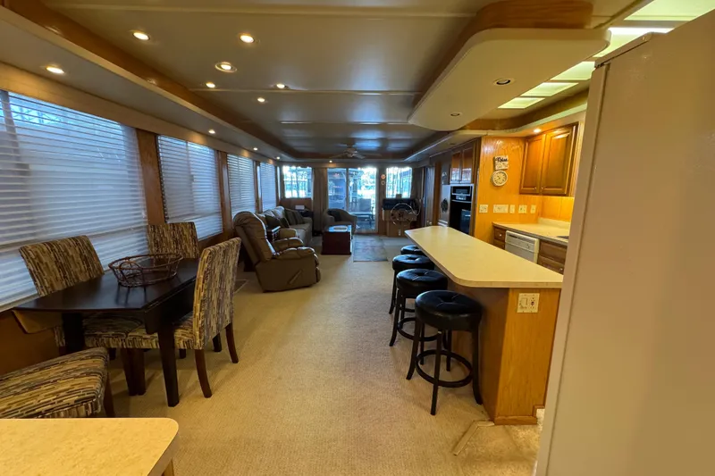 Slide: The Image of 2002 Sumerset houseboat deck with seating, table, and scenic lake view. - 27