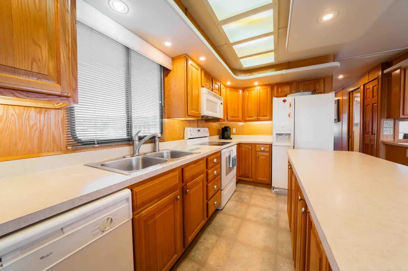 Slide: The Image of Spacious kitchen in 2002 Sumerset houseboat with wooden cabinets and modern appliances. - 35
