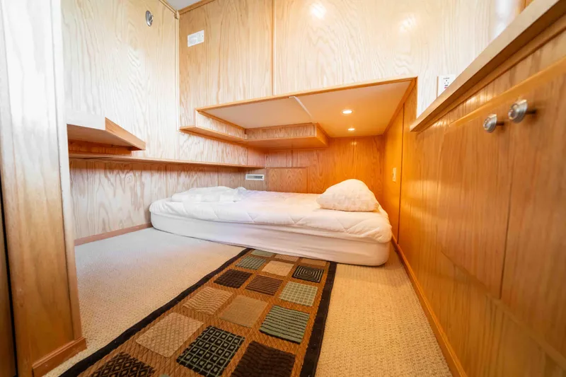 Slide: The Image of Cozy bedroom in 2002 Sumerset houseboat with wooden interior and single bed. - 40