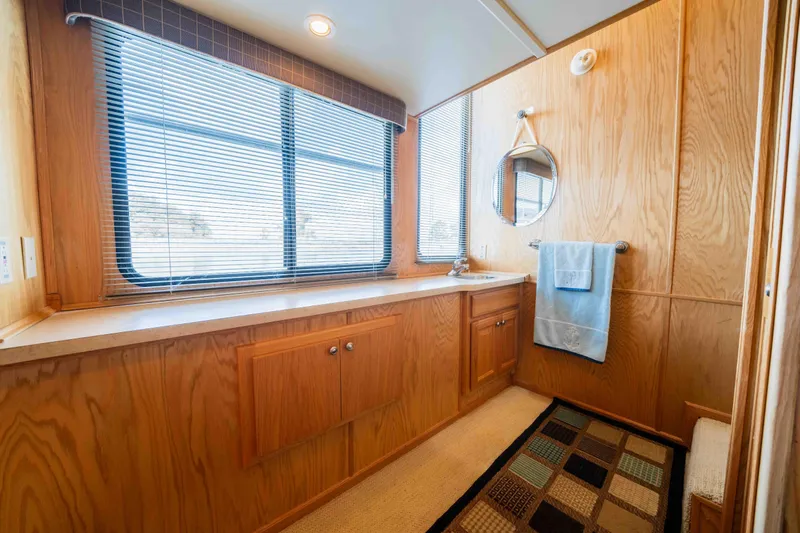 Slide: The Image of Interior of 2002 Sumerset houseboat bathroom with wood paneling and large window. - 41