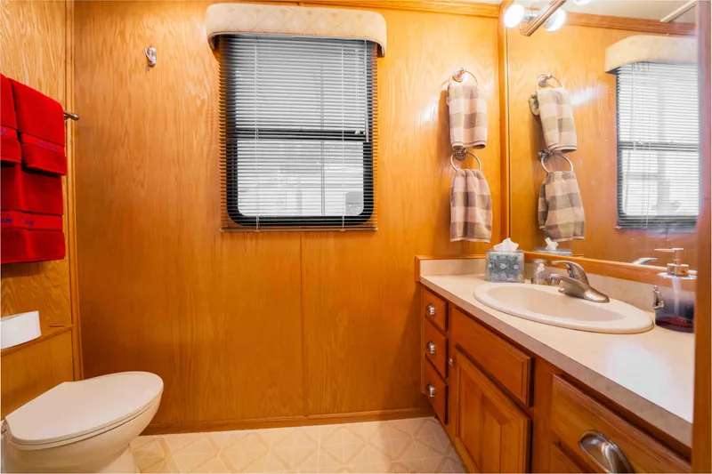 Slide: The Image of Bathroom interior of 2002 Sumerset houseboat with wooden cabinetry and modern fixtures. - 43