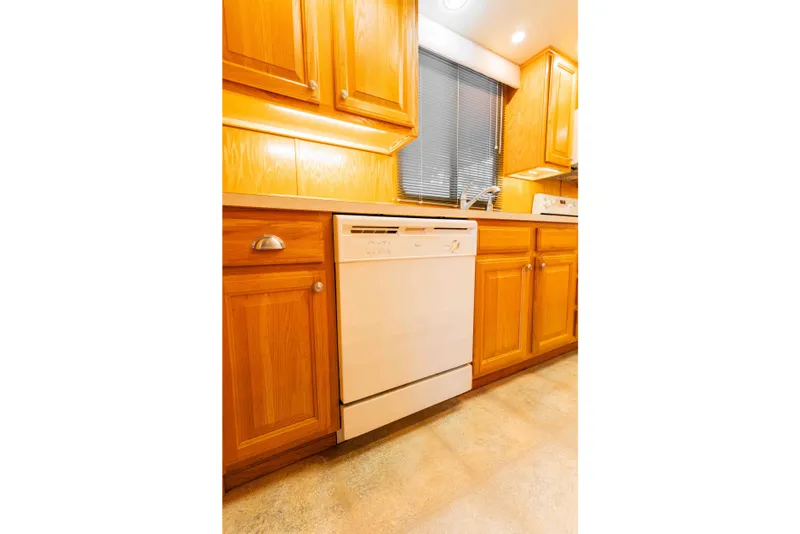 Slide: The Image of Kitchen interior of 2002 Sumerset houseboat with wooden cabinets and dishwasher. - 47