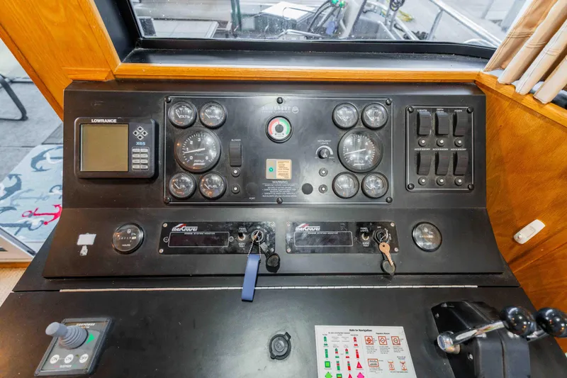Slide: The Image of Control panel of a 2002 Sumerset houseboat with gauges and navigation equipment. - 52