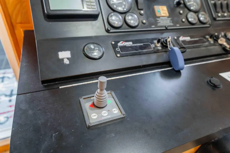 Slide: The Image of Control panel of a 2002 Sumerset Houseboat with joystick and gauges. - 54