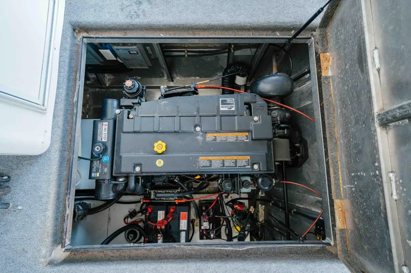 Slide: The Image of Engine compartment of a 2002 Sumerset Houseboat, showcasing mechanical components and wiring. - 58