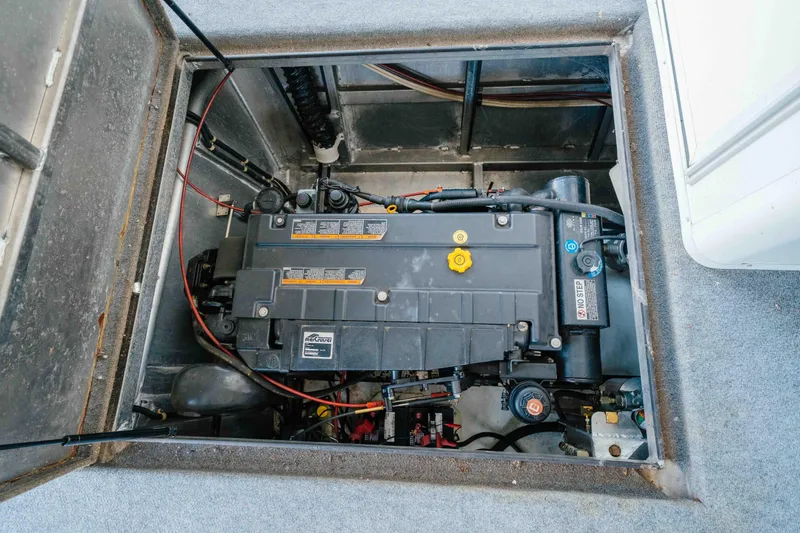 Slide: The Image of Engine compartment of a 2002 Sumerset houseboat, featuring a well-maintained Mercury engine. - 59