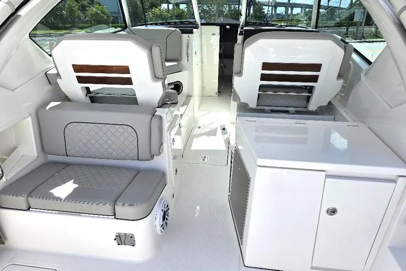 Slide: The Image of 2024 Pursuit DC 326 Dual Console interior with seating and storage features. - 11