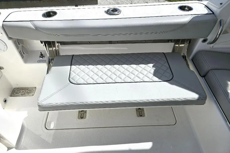 Slide: The Image of 2024 Pursuit DC 326 Dual Console boat seat with quilted design and cup holders. - 13