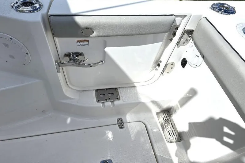 Slide: The Image of 2024 Pursuit DC 326 Dual Console boat interior with open hatch and seating area. - 17