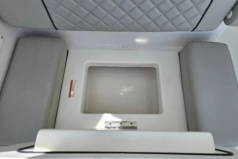 Slide: The Image of 2024 Pursuit DC 326 Dual Console interior storage compartment with cushioned seating. - 19