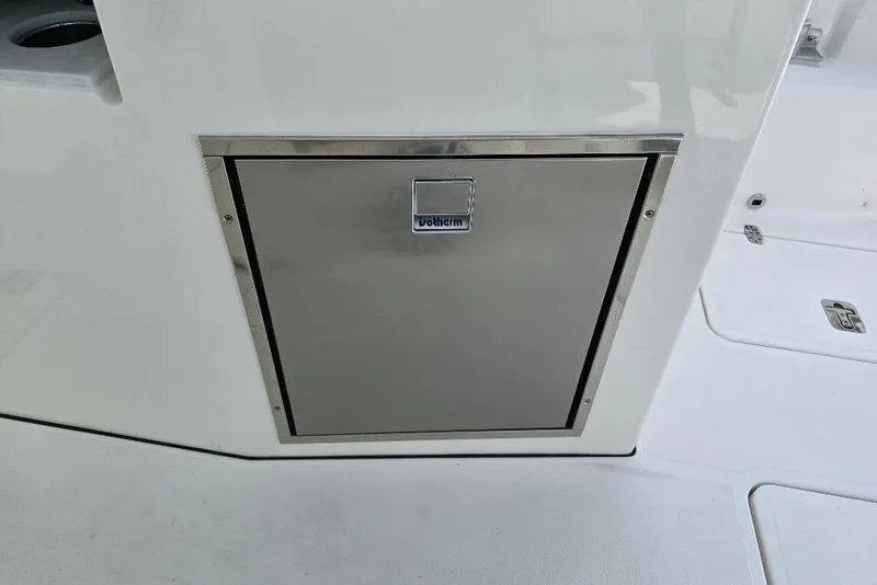 Slide: The Image of 2024 Pursuit DC 326 Dual Console, stainless steel storage compartment detail. - 20