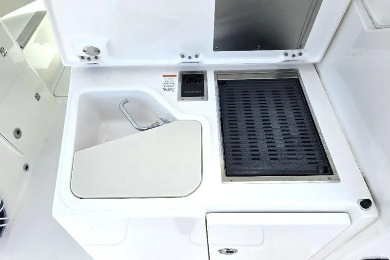 Slide: The Image of 2024 Pursuit DC 326 Dual Console boat sink and grill station. - 21