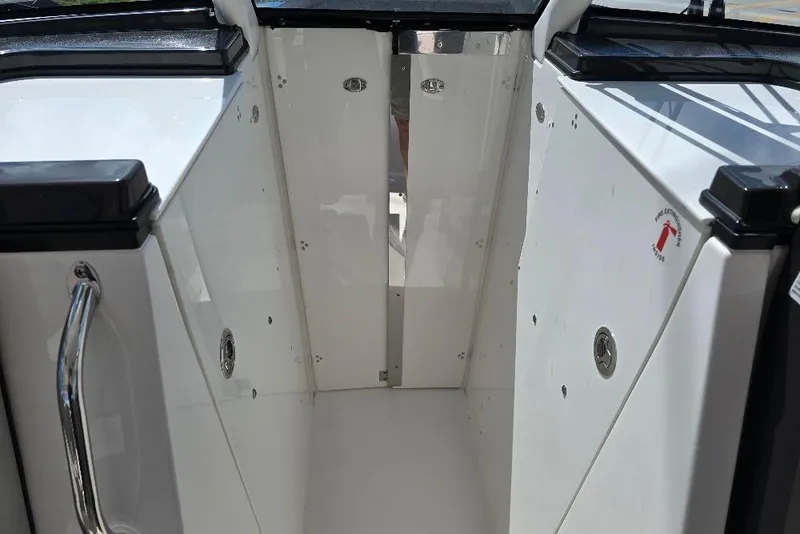 Slide: The Image of 2024 Pursuit DC 326 Dual Console interior with sleek white finish and stainless steel accents. - 23