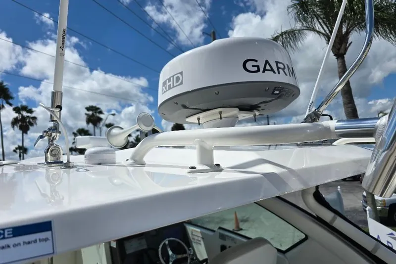 Slide: The Image of 2024 Pursuit DC 326 Dual Console with Garmin radar, clear sky background. - 30