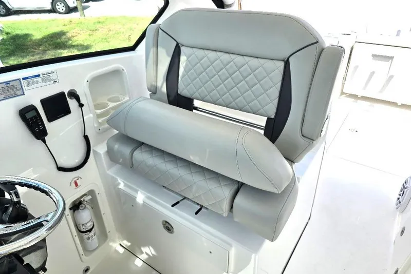 Slide: The Image of 2024 Pursuit DC 326 Dual Console boat interior with luxurious seating and modern controls. - 7