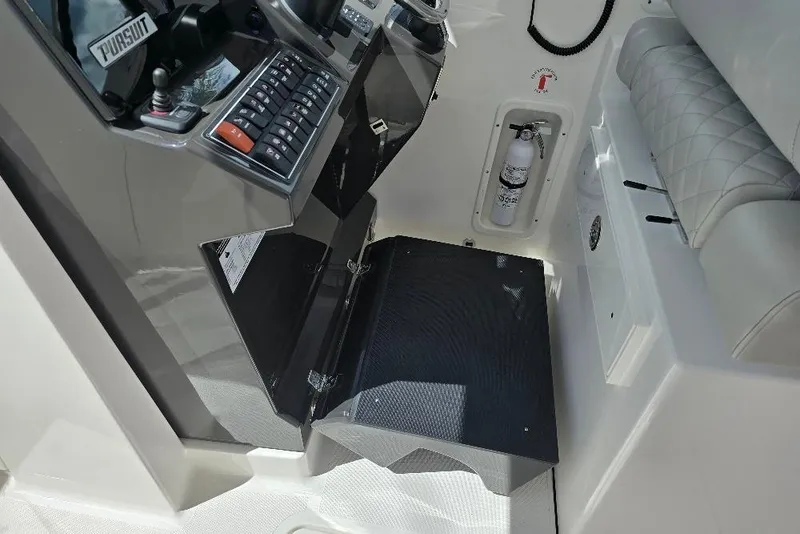 Slide: The Image of 2024 Pursuit DC 326 Dual Console interior with control panel and fire extinguisher. - 9