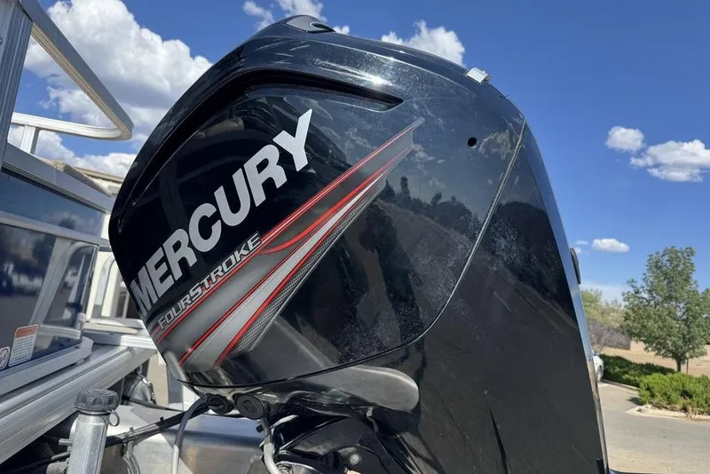 Slide: The Image of Mercury FourStroke engine on 2017 Sun Tracker FISHIN' BARGE® 20 DLX under blue sky. - 11