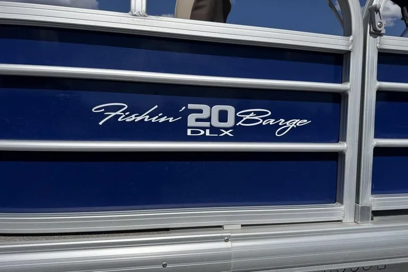 Slide: The Image of 2017 Sun Tracker FISHIN' BARGE® 20 DLX pontoon boat side view with logo. - 12