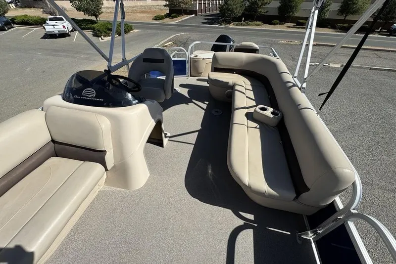 Slide: The Image of 2017 Sun Tracker FISHIN' BARGE® 20 DLX interior with beige seating and steering console. - 26