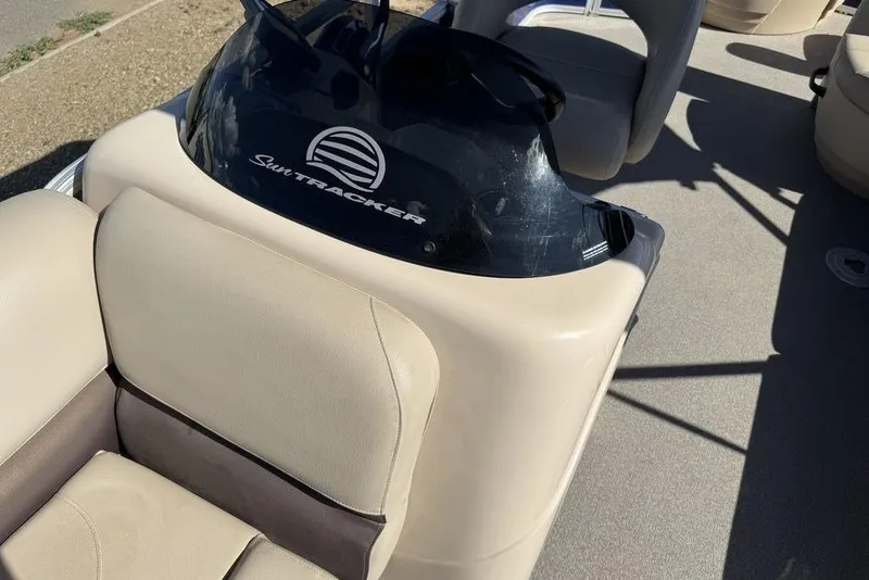 Slide: The Image of 2017 Sun Tracker FISHIN' BARGE® 20 DLX interior with beige seating and console. - 33