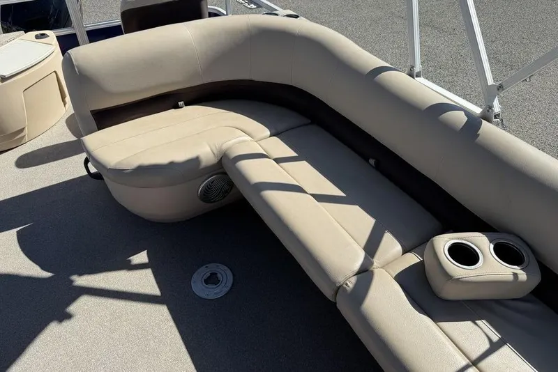 Slide: The Image of 2017 Sun Tracker FISHIN' BARGE® 20 DLX boat interior with beige seating and cup holders. - 35