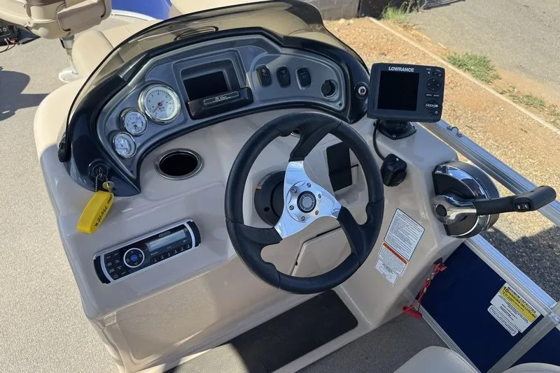 Slide: The Image of 2017 Sun Tracker FISHIN' BARGE® 20 DLX dashboard with steering wheel and controls. - 36