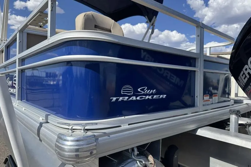 Slide: The Image of 2017 Sun Tracker FISHIN' BARGE® 20 DLX pontoon boat, blue exterior, close-up view. - 4