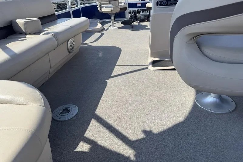 Slide: The Image of 2017 Sun Tracker FISHIN' BARGE® 20 DLX interior with beige seating and carpeted floor. - 47