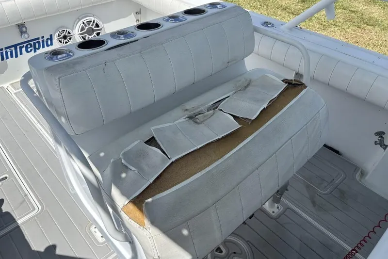 Slide: The Image of Damaged seat on 2000 Intrepid 322 Cuddy boat with cup holders and speaker. - 15