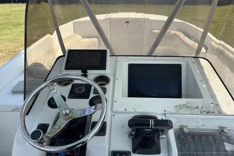 Slide: The Image of Helm of 2000 Intrepid 322 Cuddy with steering wheel and navigation equipment. - 16