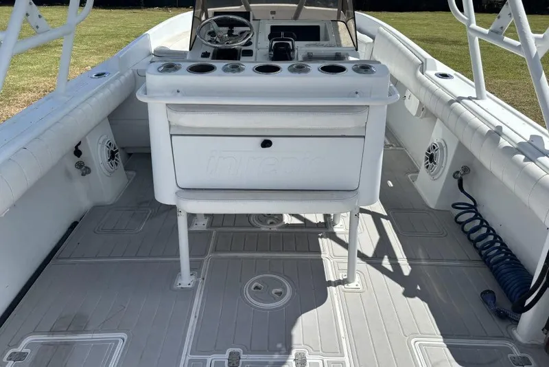 Slide: The Image of 2000 Intrepid 322 Cuddy boat interior with steering console and seating. - 17