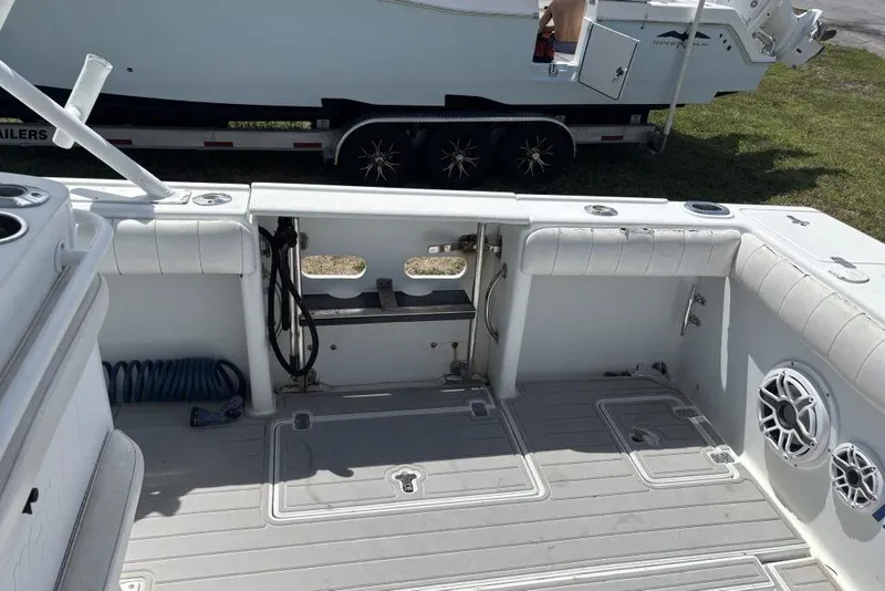 Slide: The Image of 2000 Intrepid 322 Cuddy boat interior with seating and storage compartments. - 20