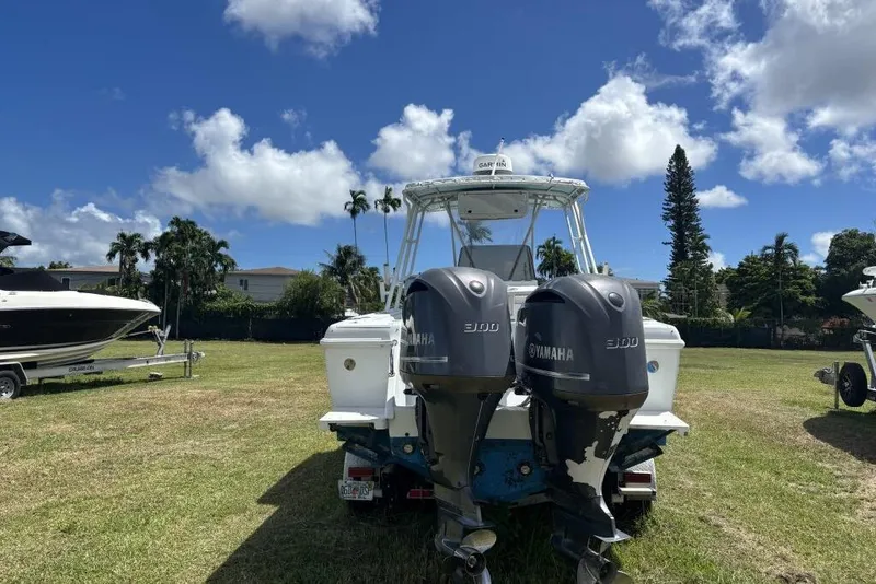 Slide: The Image of 2000 Intrepid 322 Cuddy boat with twin Yamaha 300 engines on grassy field. - 6