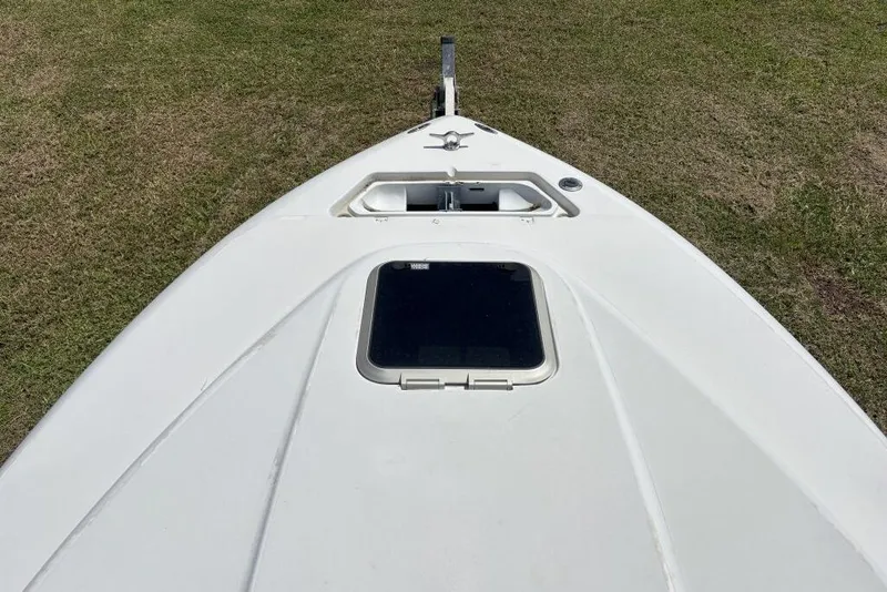 Slide: The Image of Bow view of 2000 Intrepid 322 Cuddy boat on grass. - 9