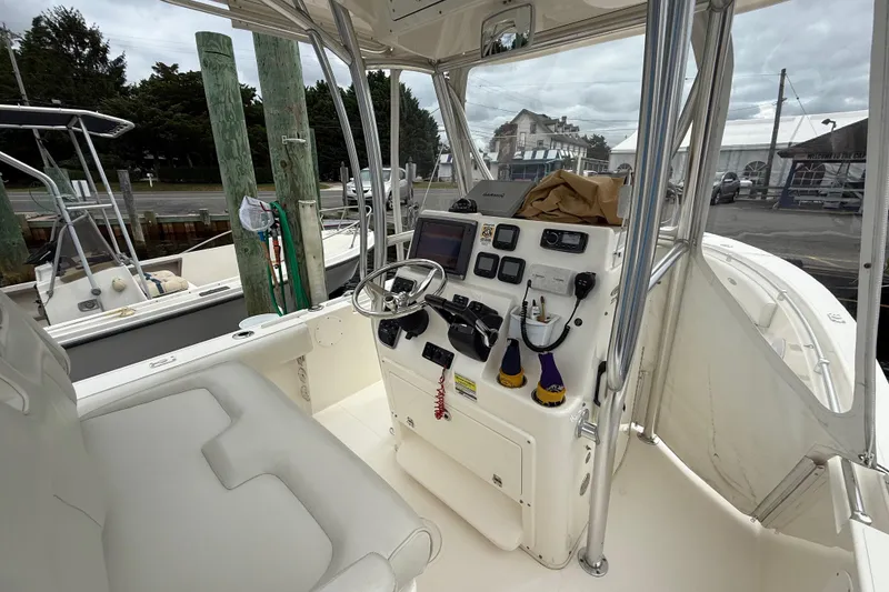 Slide: The Image of 2015 Cobia 256 Center Console boat interior with steering wheel and control panel. - 30