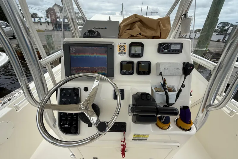 Slide: The Image of 2015 Cobia 256 Center Console boat dashboard with Garmin navigation system and controls. - 31