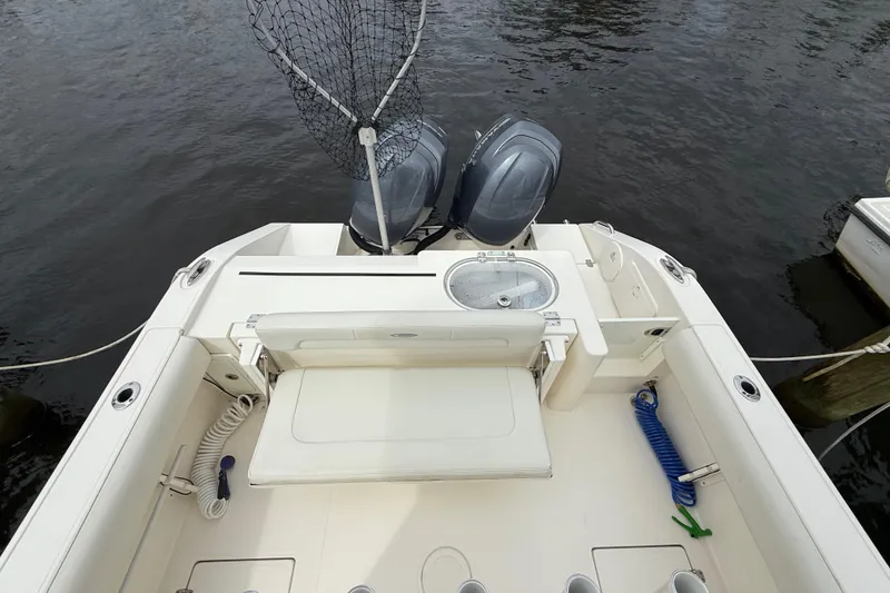 Slide: The Image of 2015 Cobia 256 Center Console boat with dual engines and fishing gear. - 33