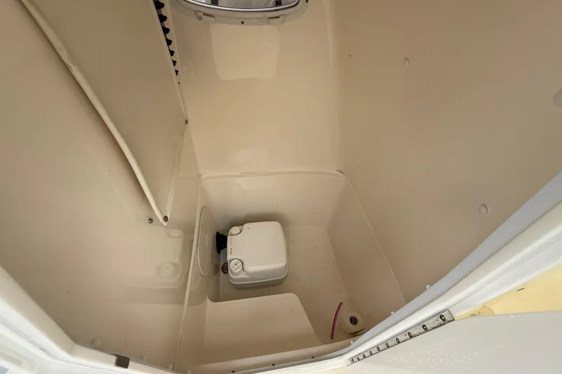 Slide: The Image of 2015 Cobia 256 Center Console boat interior with compact toilet. - 34
