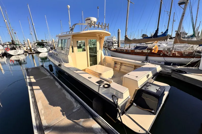 The Image of 2003 Albin 28 TE boat docked in a marina, surrounded by sailboats. - 0